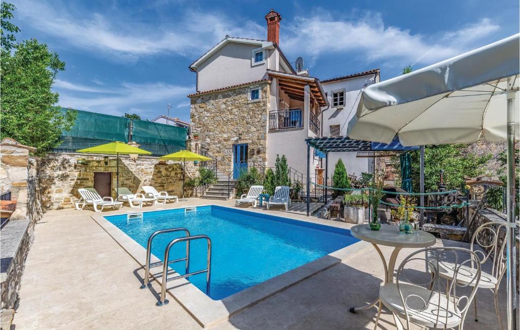 a swimming pool in front of a house at Holiday Home Kamena Vas Kamena Vas in Karojba