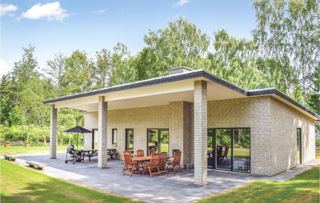 a brick house with a patio at Four-Bedroom Holiday Home In Ebeltoft in Ebeltoft