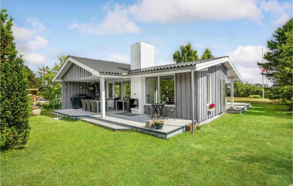 a tiny house in a garden with a patio at Lovely Home In Juelsminde With Kitchen in Sønderby