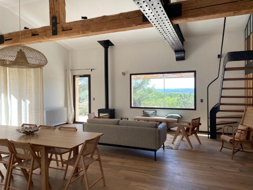 La canopée, Bastide sur les hauteurs de Lourmarin في لورمارين: غرفة معيشة بها أريكة وطاولة