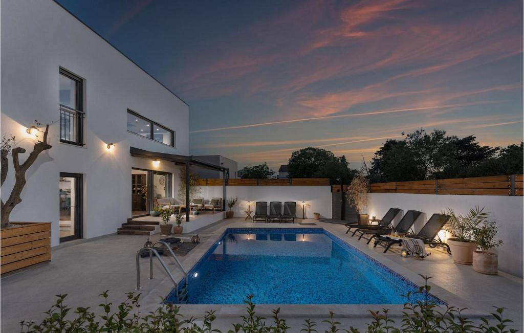 a swimming pool in the backyard of a house at Villa Arcus in Pakoštane