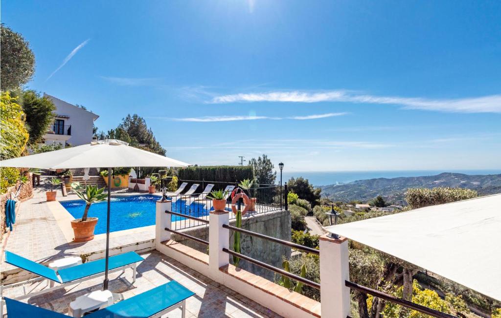 a villa with a pool and a view at 7 Bedroom Stunning Home In Frigiliana in Acebuchal