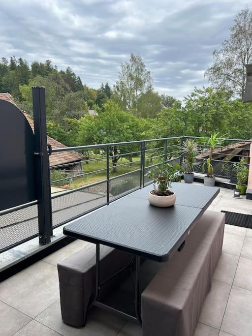 d'une table et d'un banc sur un balcon. dans l'établissement Appartement Hohwald terrasse 101, au Hohwald