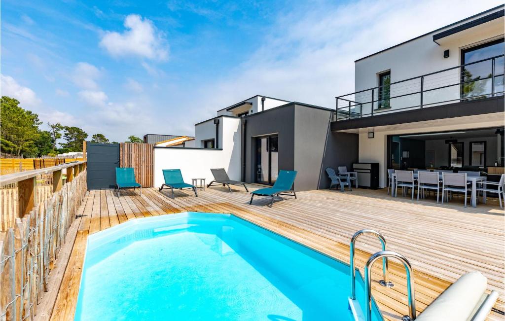 a house with a swimming pool on a wooden deck at Cozy Home In Stjean De Monts in Saint-Jean-de-Monts