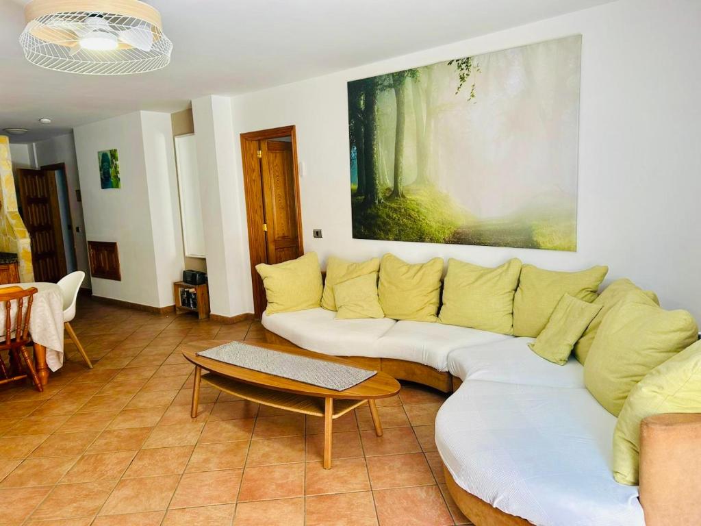 a living room with a white couch and a table at Family and Friends , Familienapartment Playa de San Juan in Guía de Isora