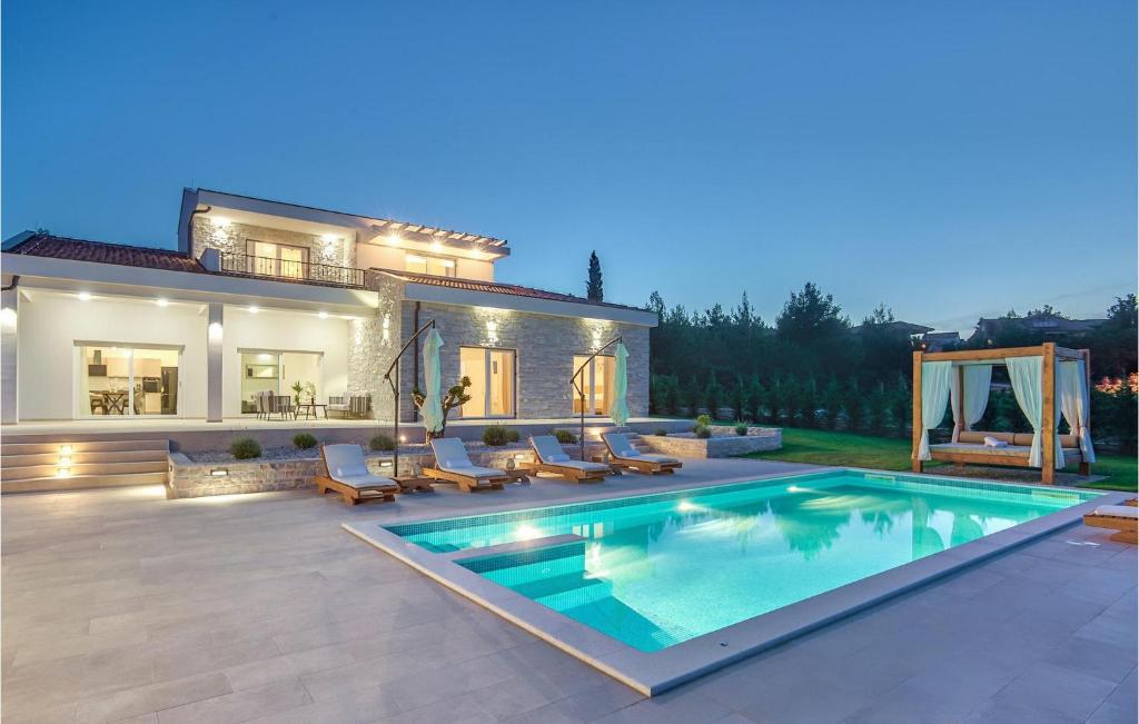 a house with a swimming pool in front of a house at Villa Ena Mar in Zadar