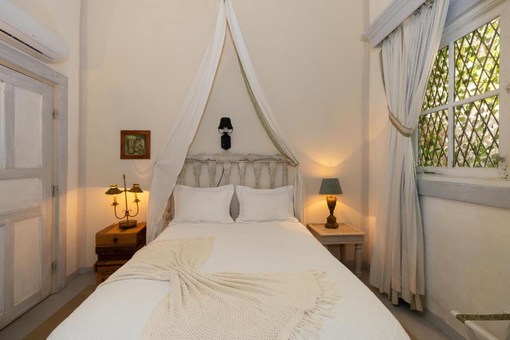 Postel nebo postele na pokoji v ubytování Villa Caprichosa Boutique Hotels