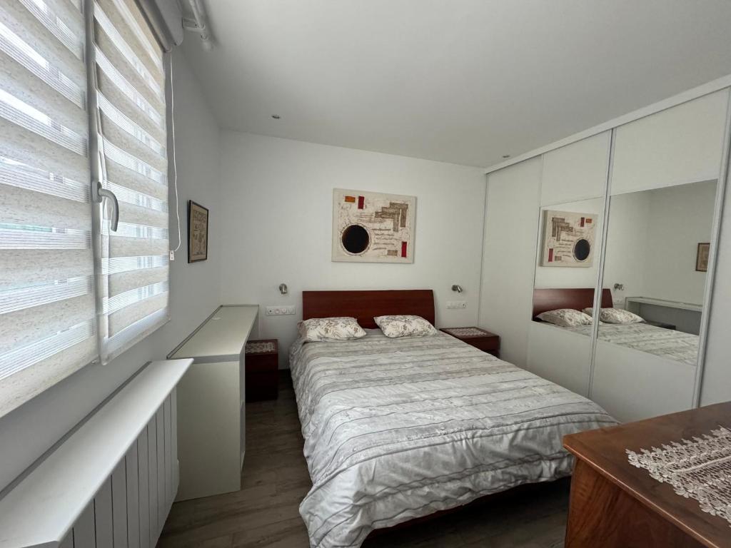 a bedroom with a bed and a large window at Charmante maison avec terrasse in Auterive