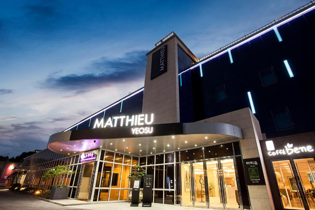 a store front of a shopping center with lights at Hotel Matthieu Yeosu in Yeosu