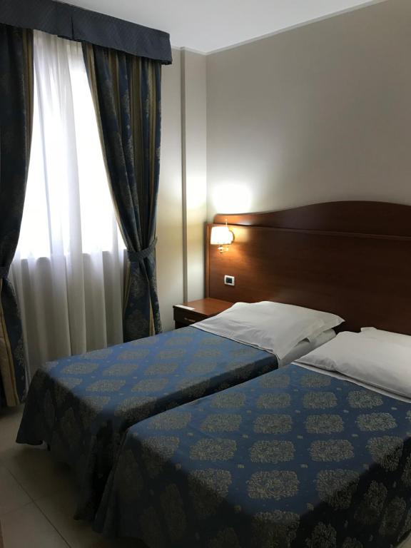Postel nebo postele na pokoji v ubytování Hotel Rigolfo