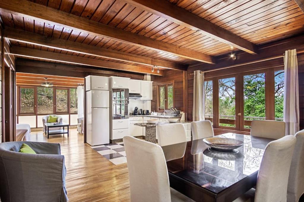 a kitchen and dining room with a table and chairs at Chalet Flambwayan, quiet, peaceful and well located in Les Anses-dʼArlets