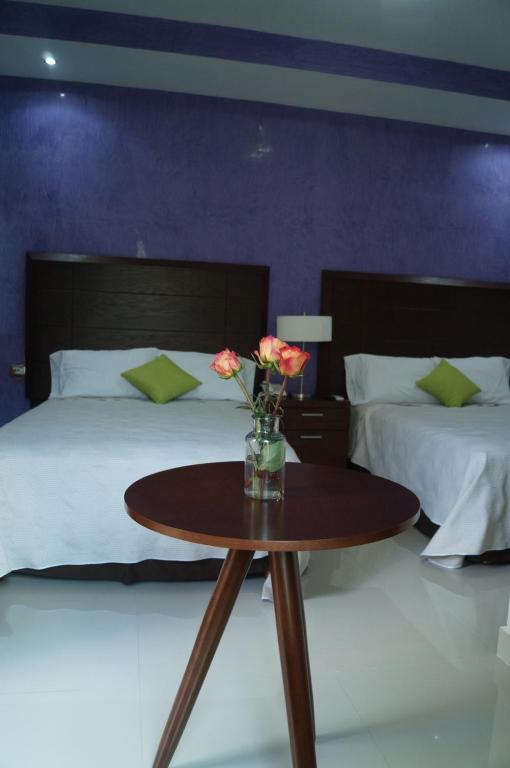 Postel nebo postele na pokoji v ubytování Hotel Casa Palomino