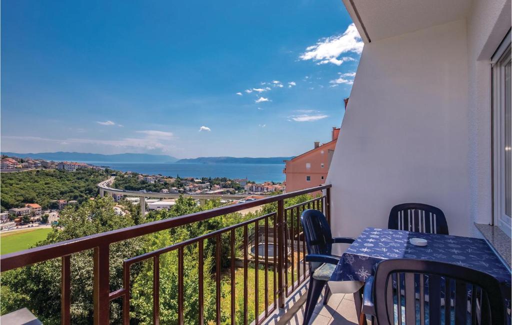 a balcony with a table and chairs and a view of the ocean at Gorgeous Apartment In Crikvenica in Crikvenica