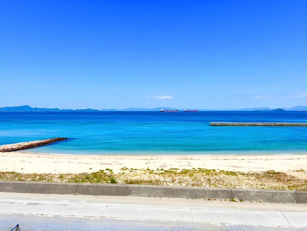 a view of a beach with blue water at HOJO Brewing & Stays - Vacation STAY 17946 in Matsuyama