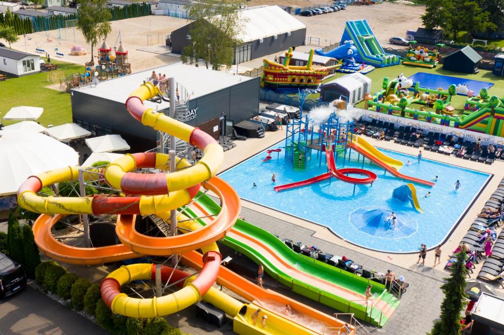 an aerial view of a water park with a water slide at Holiday Golden Resort & Spa in Łazy