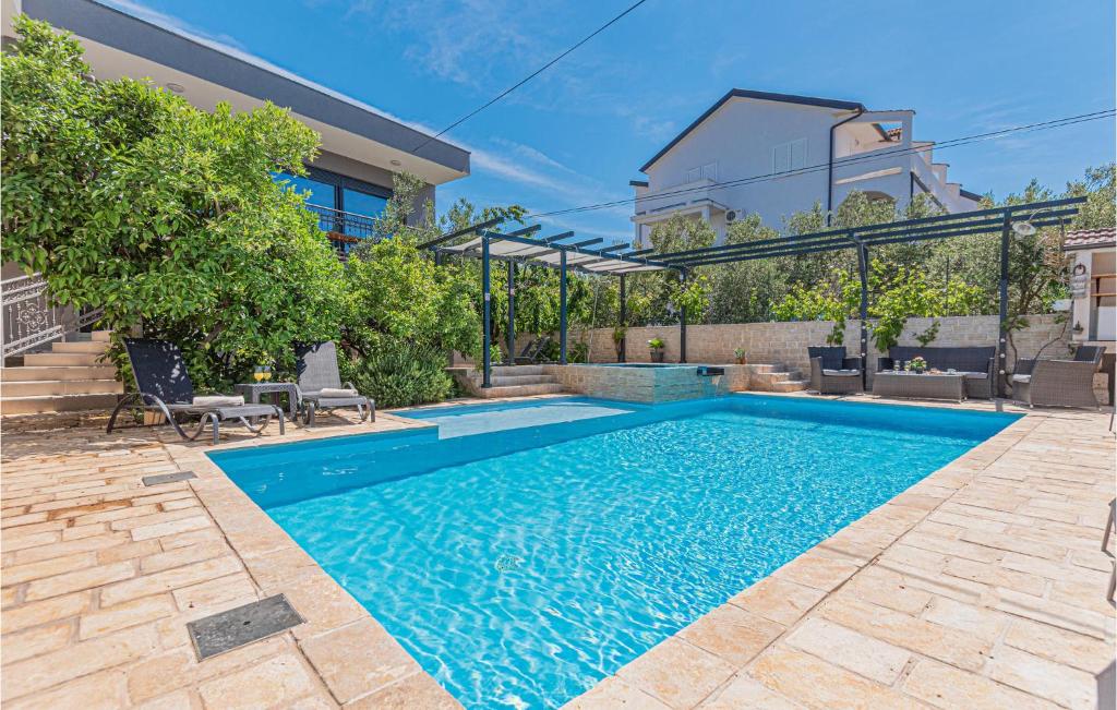a swimming pool in the backyard of a house at 1 Bedroom Lovely Apartment In Brodarica in Brodarica