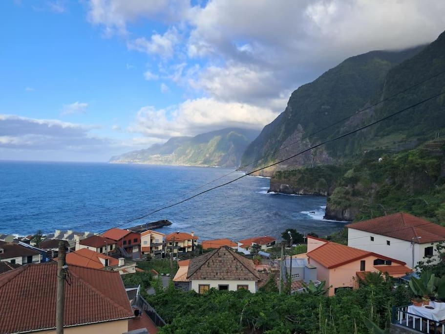 a view of a town with the ocean and mountains at Casa Vintage Seixal Madeira in Seixal
