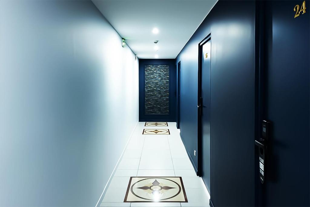 a narrow hallway with a room with a window at Hôtel de Ménilmontant in Paris