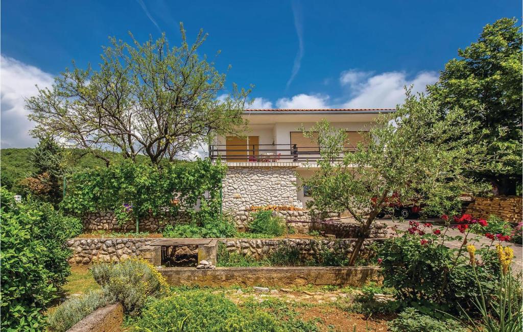 a house with a garden in front of it at Nice Apartment In Smrika With Kitchen in Šmrika