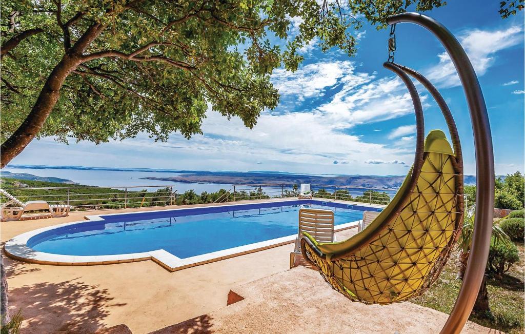 a resort style swimming pool with a swing at Lovely Home In Jablanac With Wifi in Jablanac