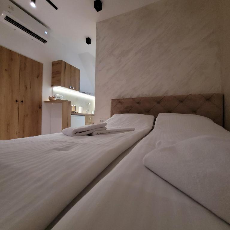 a bedroom with a large bed with white sheets at Dream House in Novi Sad