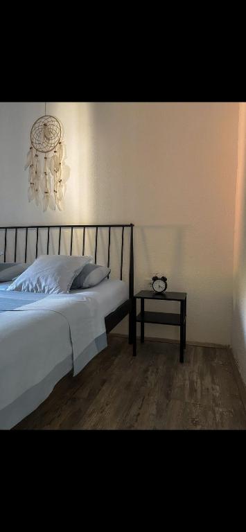 a bedroom with a bed with a chandelier and a table at Brioni House in Ribare