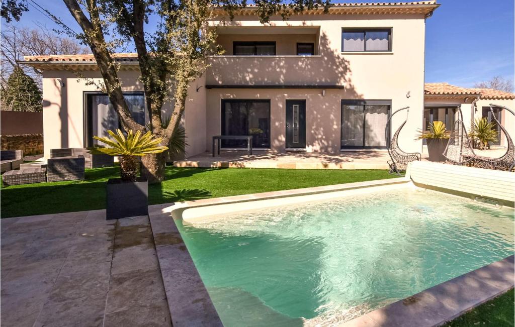 a swimming pool in front of a house at Nice Home In Colonzelle With Wifi in Colonzelle