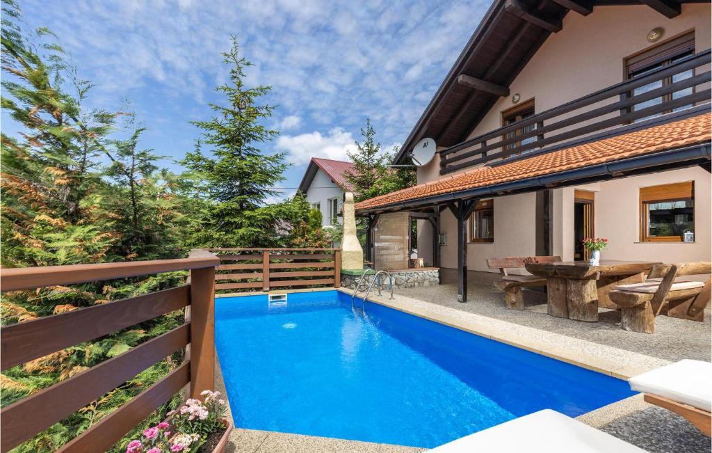 a swimming pool in the backyard of a house at Pet Friendly Home In Vrata With Sauna in Vrata