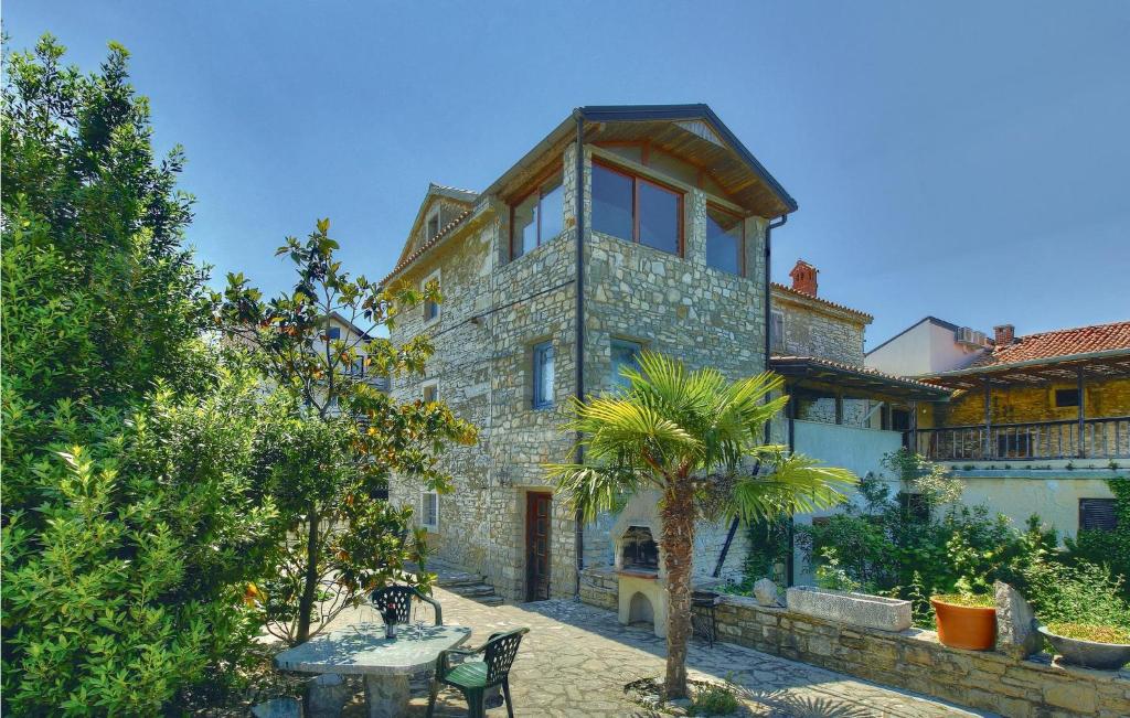 a large stone house with a table in front of it at Cozy Home In Kastel With Wifi in Kaštel