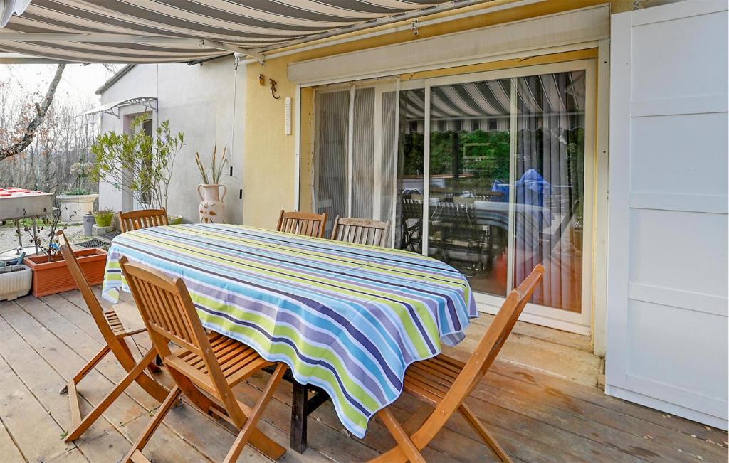 a table and chairs on a patio with a table and a window at 1 Bedroom Awesome Home In Saint-Denis in Saint-Denis