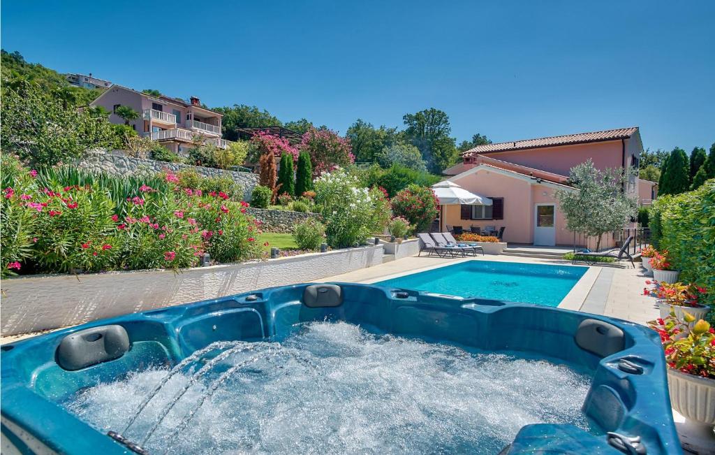 a pool with a water slide in a yard at Stunning Home In Labin in Labin