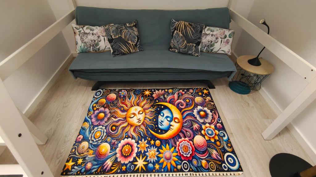 an overhead view of a couch with a colorful rug at Casa Luna y Sol in Puerto del Rosario