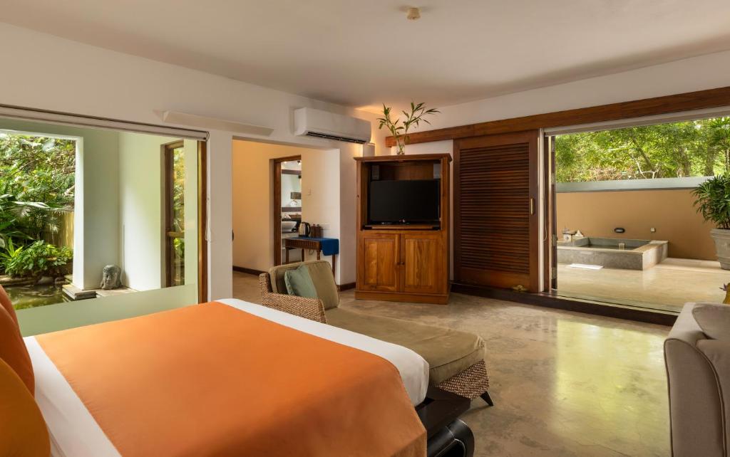 A bed or beds in a room at Aditya Resort