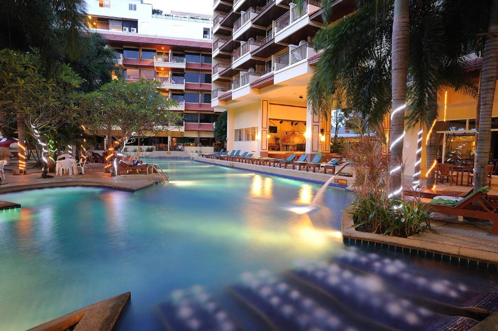 a swimming pool in a building with a hotel at Bauman Grand in Patong Beach