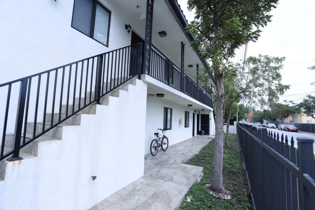 Hotel Apartments Little Habana near calle 8, a bike parked next to a white building with a staircase at Apartments Little Habana near calle 8 in Miami