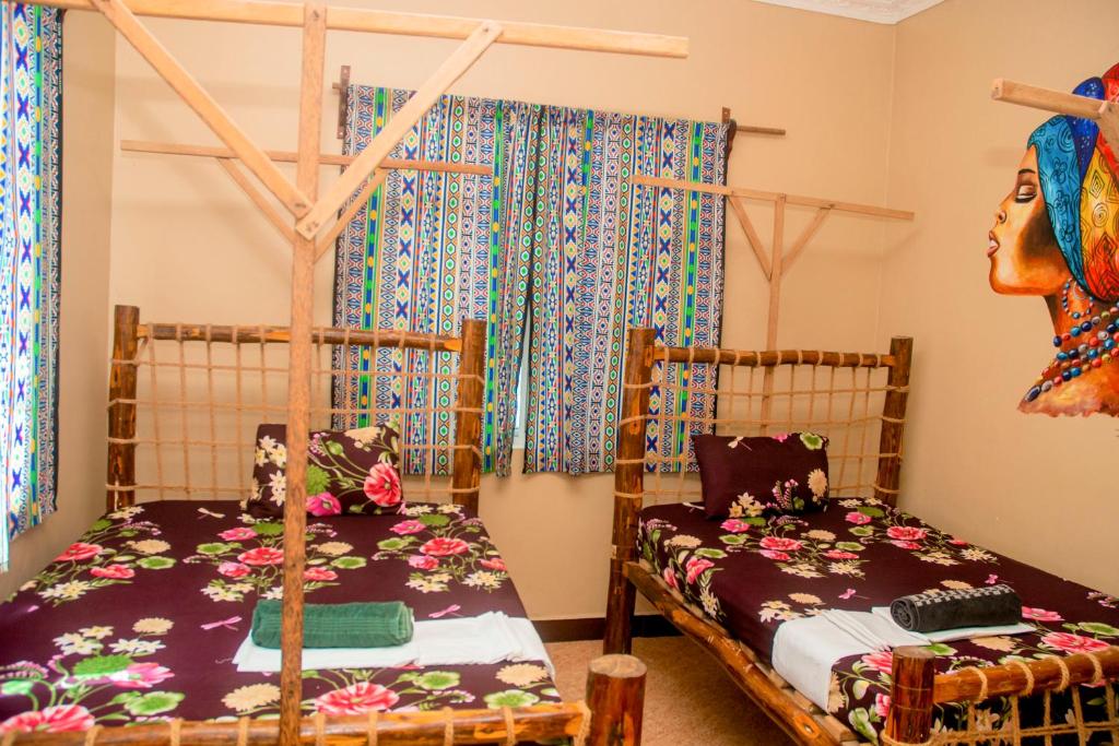 Postel nebo postele na pokoji v ubytování Palm Tree Villa Nungwi