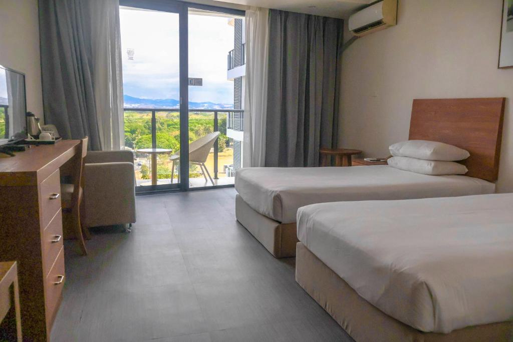 Rúm í herbergi á Nalagi Hotel