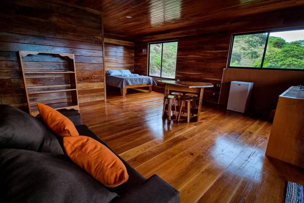 a living room with a couch and a table at Cabina vista al valle Monteverde in Monteverde Costa Rica
