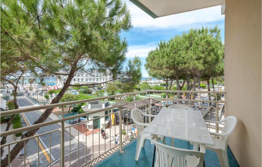a balcony with a table and chairs and trees at Cozy Apartment In Cattolica With Wifi in Cattolica
