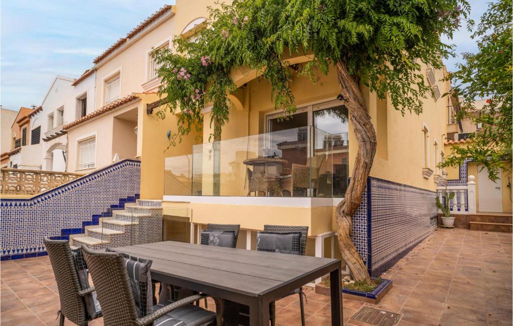 a table and chairs in front of a building at 3 Bedroom Gorgeous Home In Aguadulce in El Campillo del Moro
