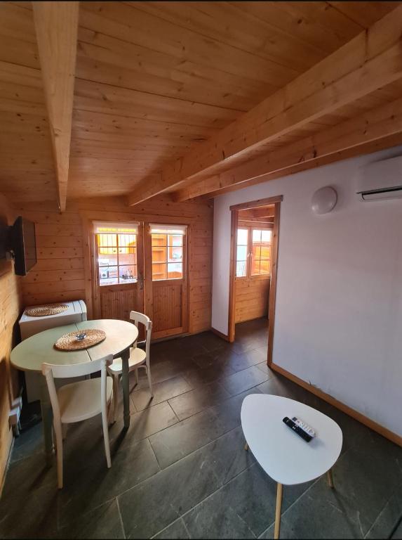 a room with two tables and a white chalkboard at La Casita de Madera in El Paso