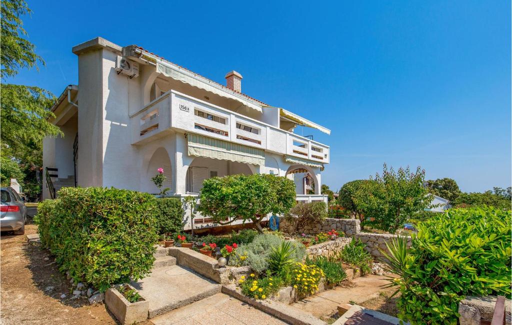 a house with a garden in front of it at 2 Bedroom Lovely Apartment In Potocnica in Potocnica
