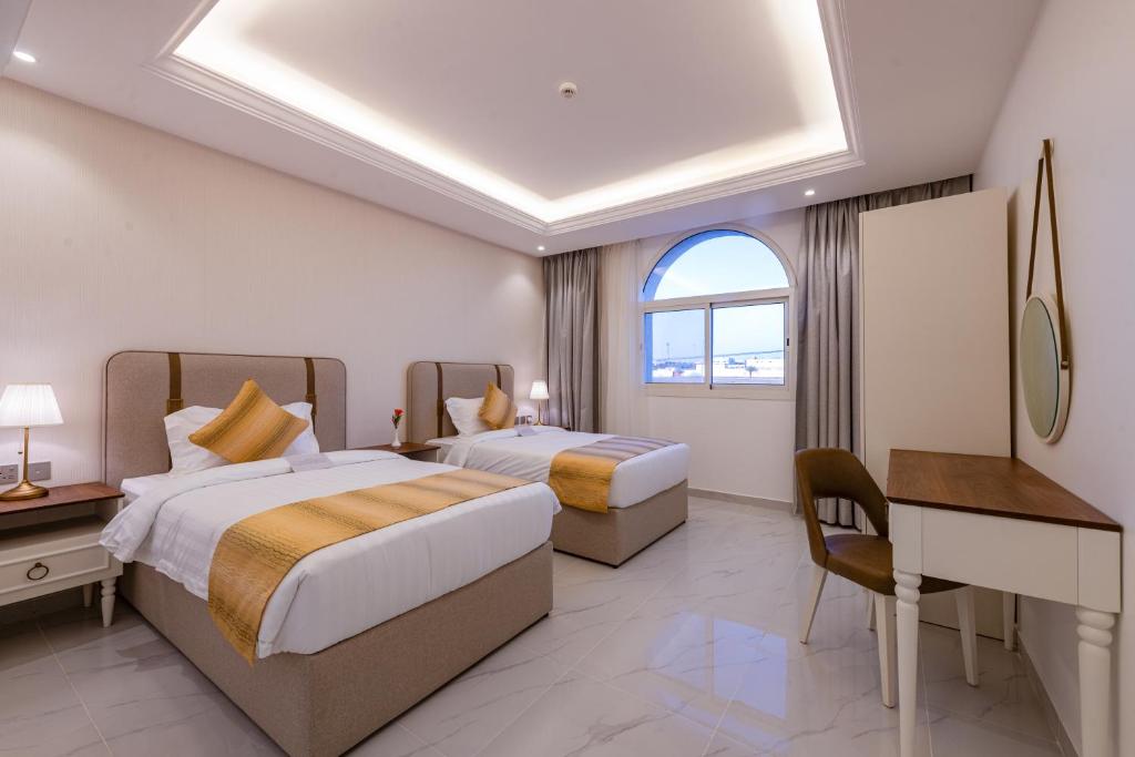 Postel nebo postele na pokoji v ubytování Neema Hotel Al Wajh