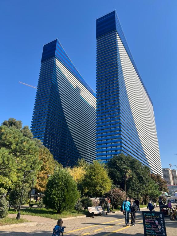two tall buildings with people walking in front of them at Orbi Batumi in Batumi