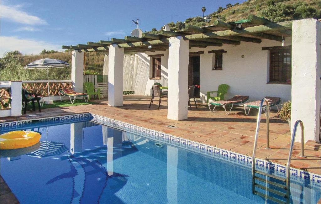 a swimming pool in front of a house at 2 Bedroom Amazing Home In Frigiliana in Frigiliana