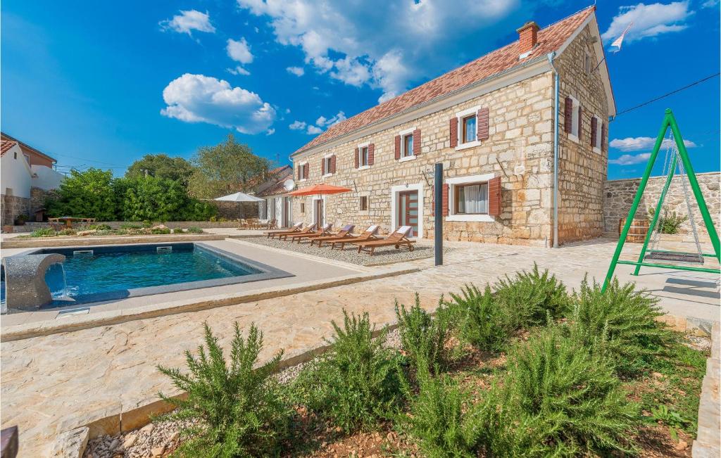 an old stone house with a swimming pool at Four-Bedroom Holiday Home In Citluk in Čitluk
