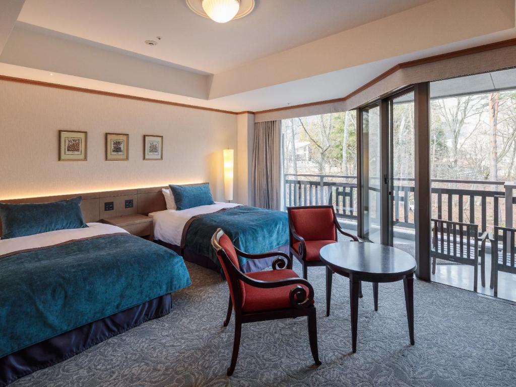 Postel nebo postele na pokoji v ubytování Hakuba Tokyu Hotel