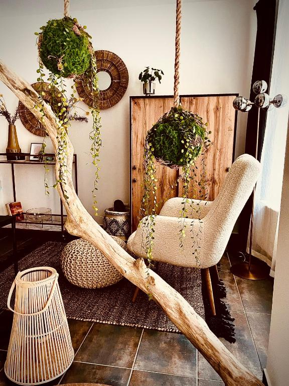 a room with two chairs and a tree branch at Lieblingsnest in Schwerin