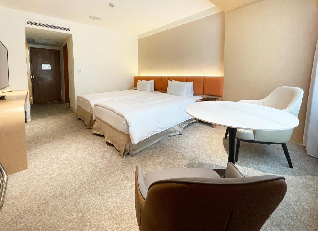 Postel nebo postele na pokoji v ubytování Hotel Tainan