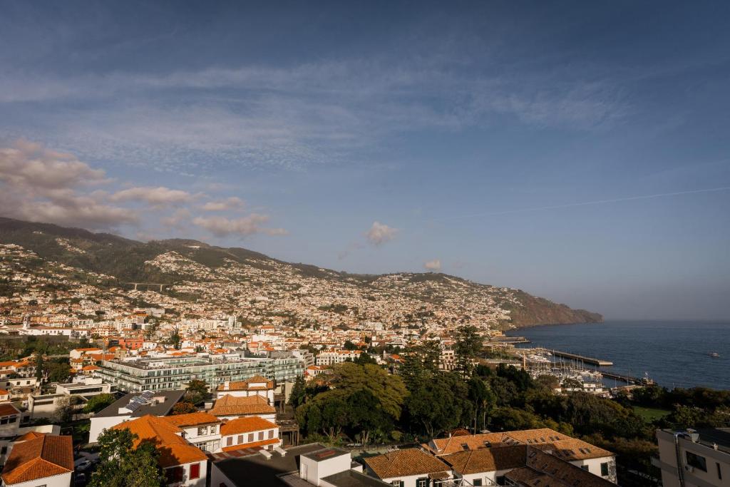 a view of a city with the ocean at Fatima`s House in Funchal